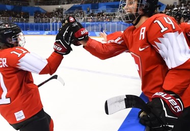 GANGNEUNG, SOUTH KOREA - FEBRUARY 18: Switzerland's Sabrina Zollinger #11 high fives Evelina Raselli #14 after scoring a first period goal on Team Korea during classification round action at the PyeongChang 2018 Olympic Winter Games. (Photo by Matt Zambonin/HHOF-IIHF Images)

